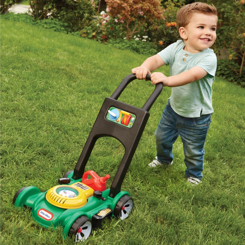 toddler pushing toy mower