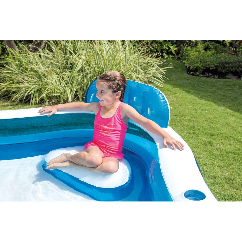 Family relaxing in garden inflatable pool UK
