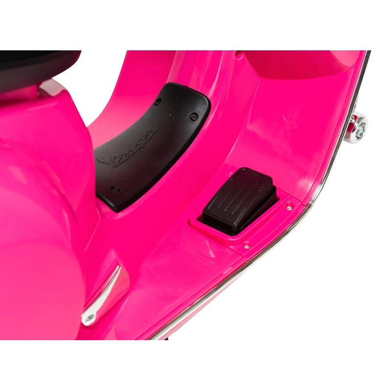 Kids playing with pink Vespa scooter