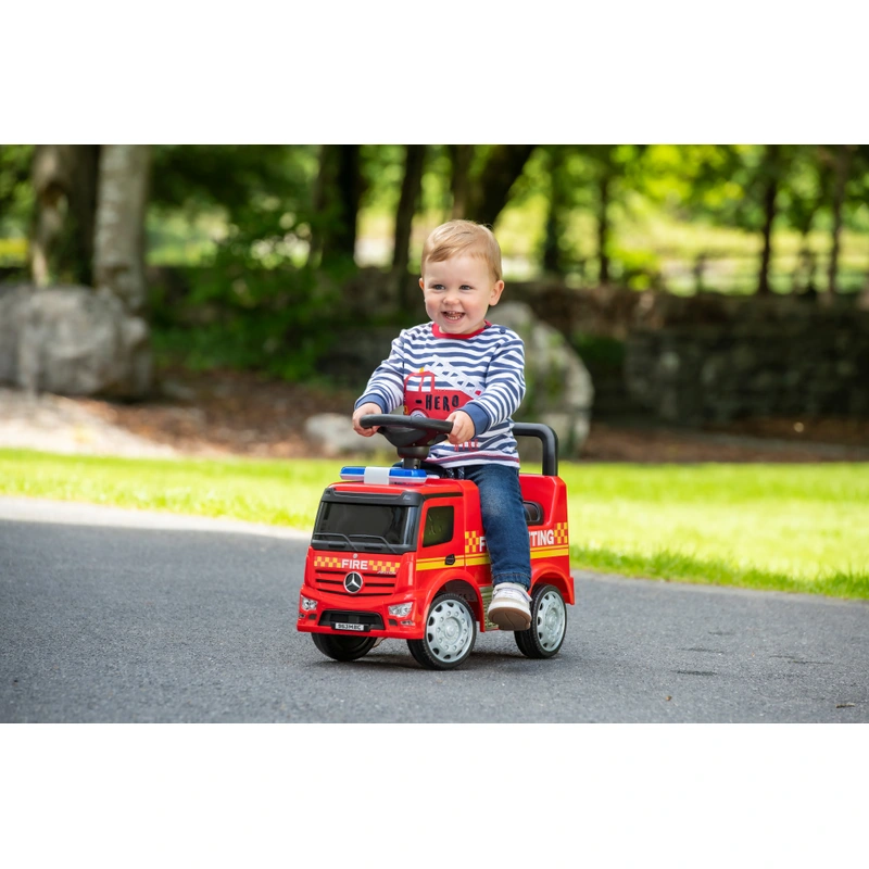 Toddler playing with Mercedes fire truck