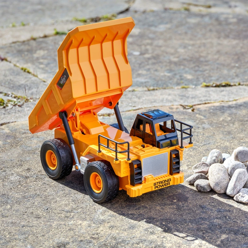 Child playing with remote control dump truck UK