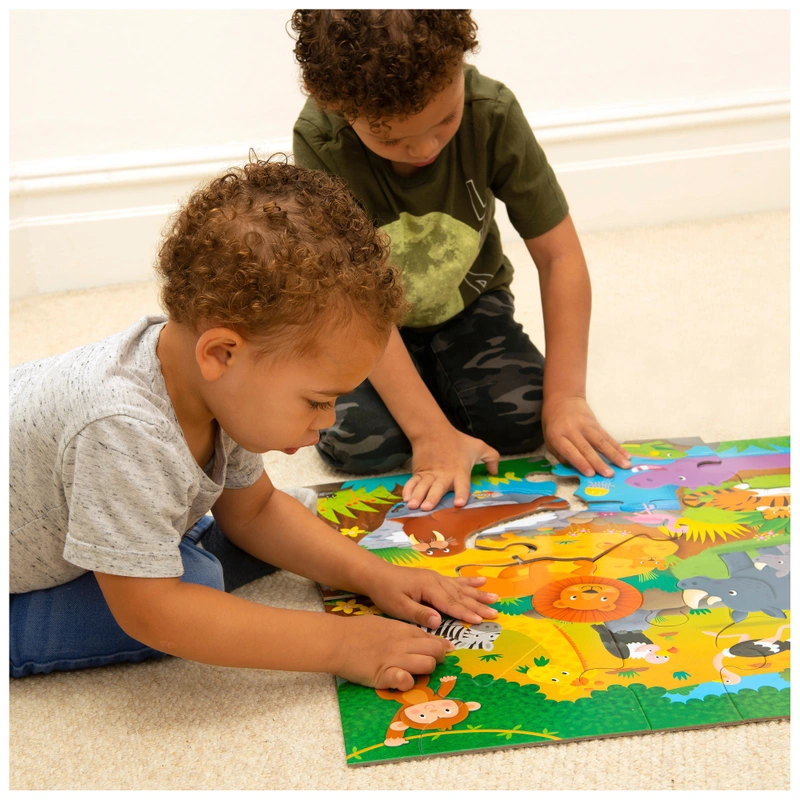 Toddler playing with Galt alphabet floor puzzle