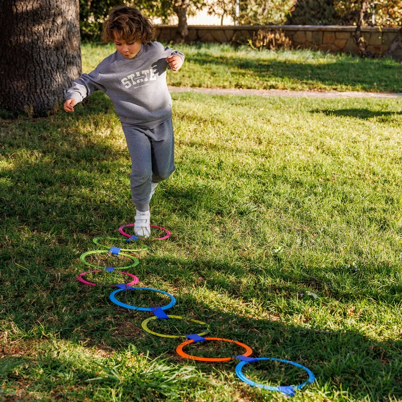 Child playing hopscotch with the modular rings