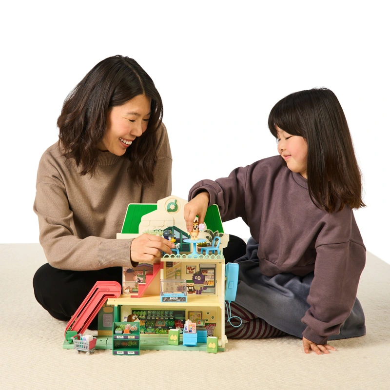 Children playing with Bluey shopping trolley toy