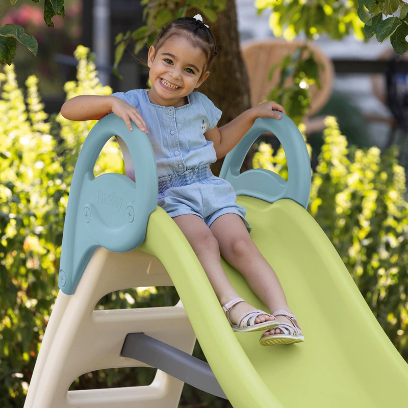 Child playing on Smoby outdoor slide UK