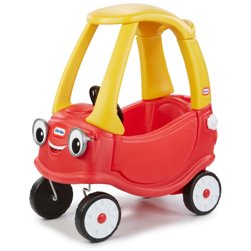 toddler driving classic Cozy Coupe in UK garden